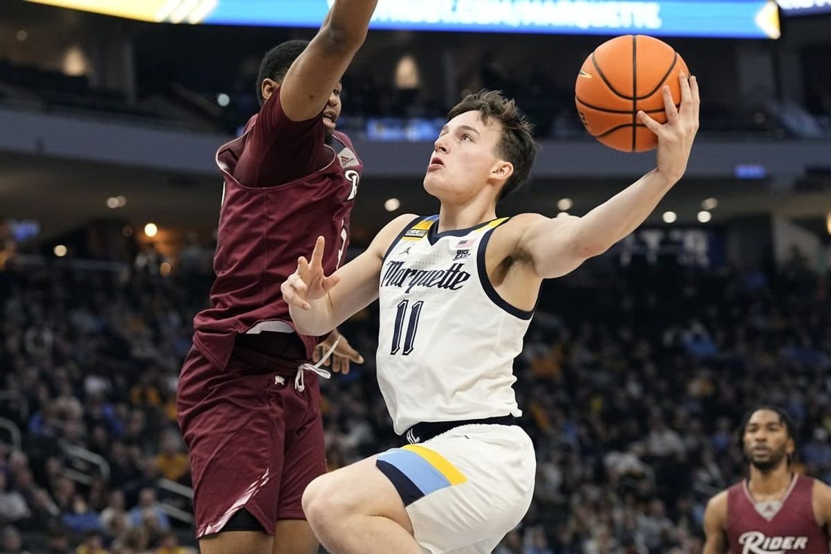 Nov 10, 2023; Milwaukee, Wisconsin, USA;  Marquette Golden Eagles guard Tyler Kolek (11) shoots against Rider Broncs forward Tariq Ingraham (33) during the first half at Fiserv Forum.