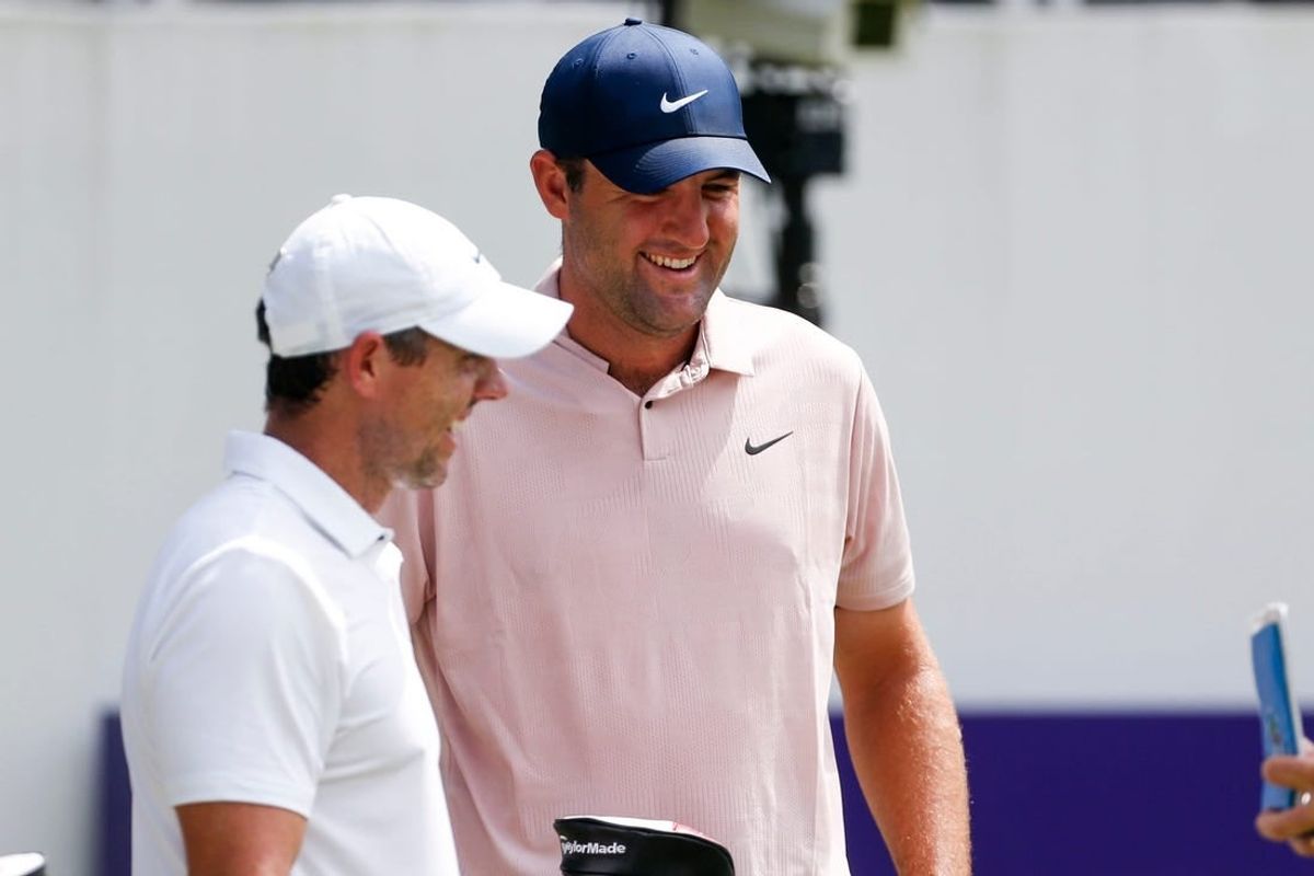 PGA Tour players Rory McIlroy and Scottie Scheffler smile before teeing off at the first hole during the third round of the FedEx St. Jude Championship at TPC Southwind in Memphis, Tenn., on Saturday, August 12, 2023.