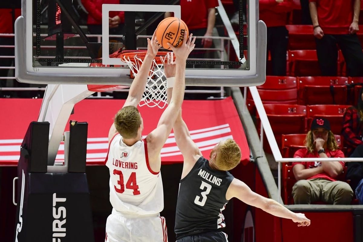 Dec 29, 2023; Salt Lake City, Utah, USA; Utah Utes center Lawson Lovering (34) dunks over Washington State Cougars guard Jabe Mullins (3) during the first half at Jon M. Huntsman Center.
