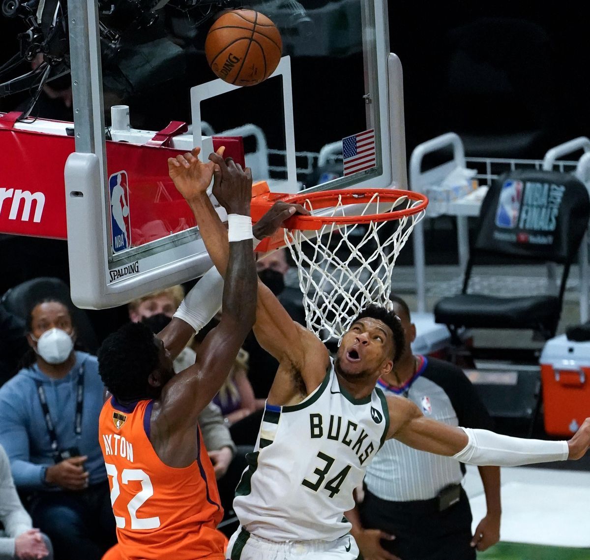 Giannis Antetokoumnpo blocks  DeAndre Ayton to preserve the lead.