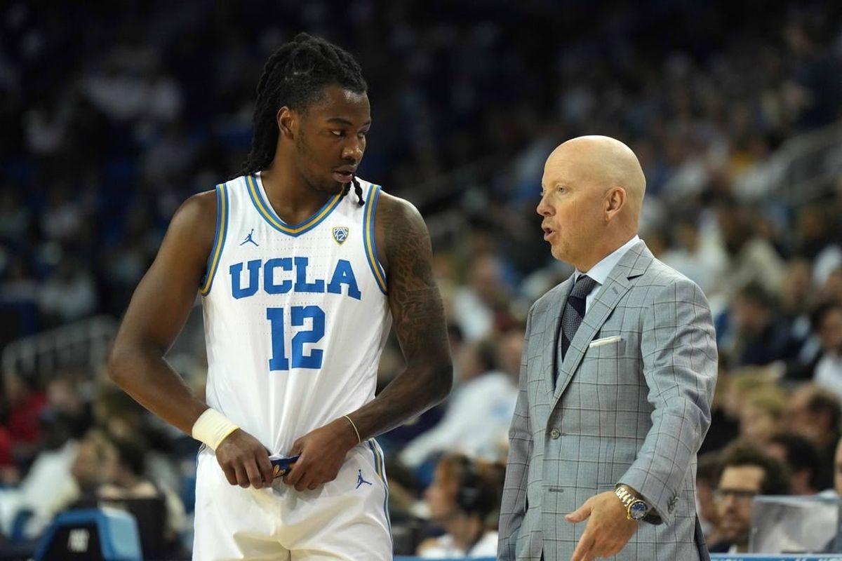 Dec 22, 2023; Los Angeles, California, USA; UCLA Bruins head coach MIck Cronin (right) talks with guard Sebastian Mack (12) against the Maryland Terrapins in the second half at Pauley Pavilion presented by Wescom.