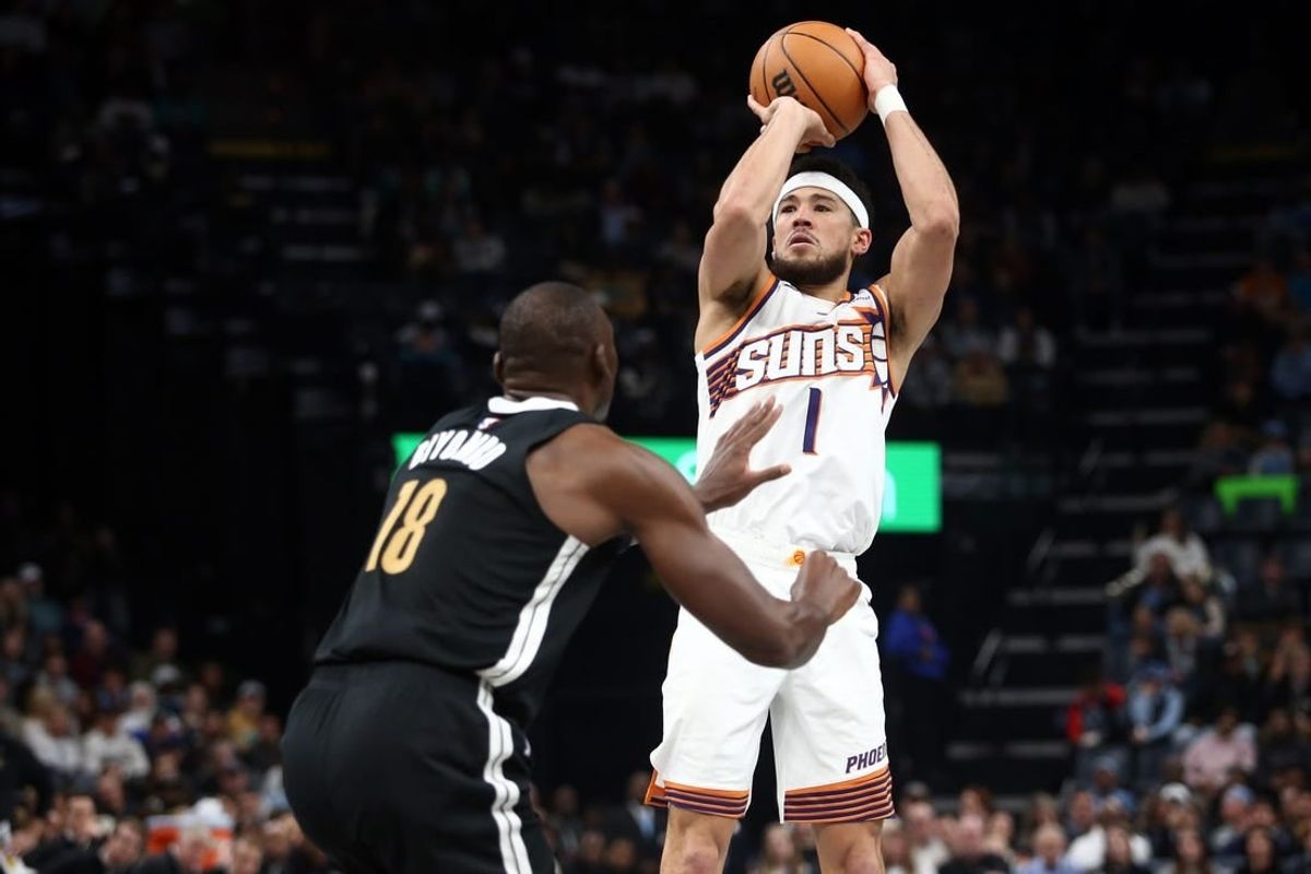 Nov 24, 2023; Memphis, Tennessee, USA; Phoenix Suns guard Devin Booker (1) shoots during the first half against the Memphis Grizzlies at FedExForum.