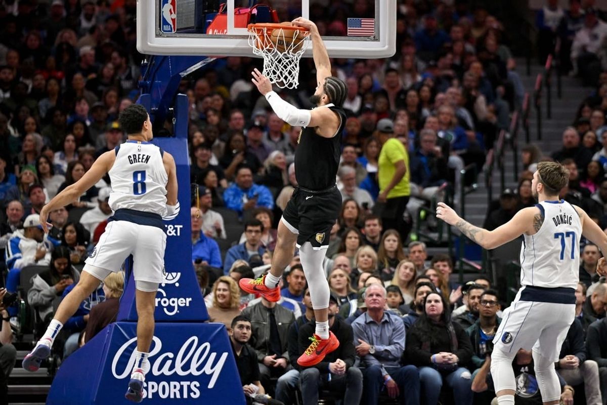 Jan 9, 2024; Dallas, Texas, USA; Memphis Grizzlies forward David Roddy (21) dunks the ball past Dallas Mavericks guard Josh Green (8) and guard Luka Doncic (77) during the second quarter at the American Airlines Center.