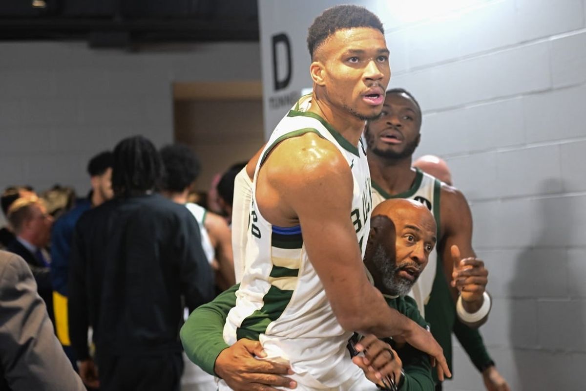 Dec 13, 2023; Milwaukee, Wisconsin, USA;  Milwaukee Bucks forward Giannis Antetokounmpo (34) is restrained by a coach outside the Indiana Pacers locker room after the game at Fiserv Forum.