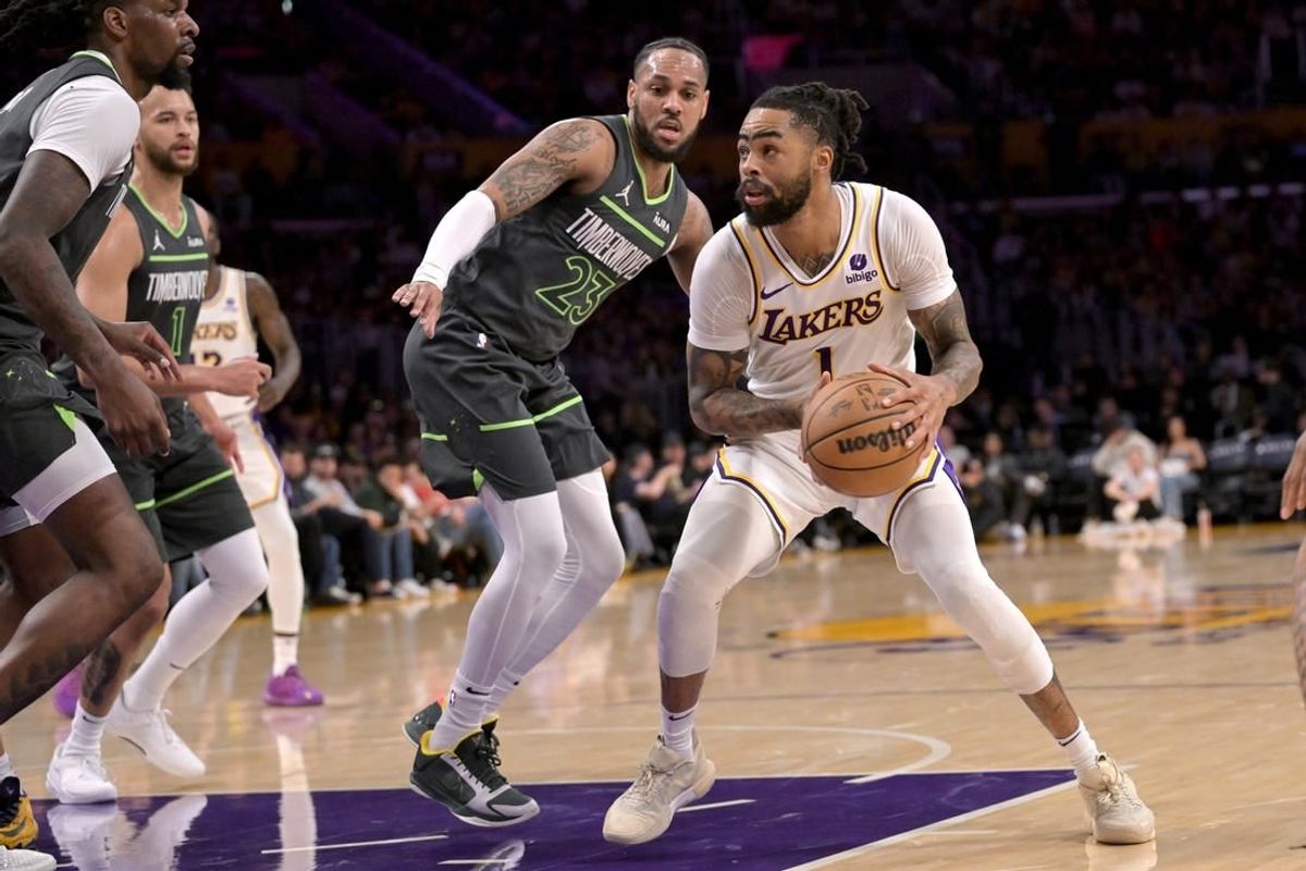Apr 7, 2024; Los Angeles, California, USA;  Los Angeles Lakers guard D'Angelo Russell (1) is defended by Minnesota Timberwolves guard Monte Morris (23) in the first half at Crypto.com Arena.