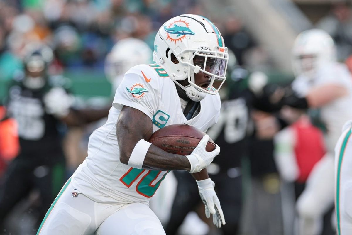 Nov 24, 2023; East Rutherford, New Jersey, USA; Miami Dolphins wide receiver Tyreek Hill (10) carries the ball during the first half against the New York Jets at MetLife Stadium.