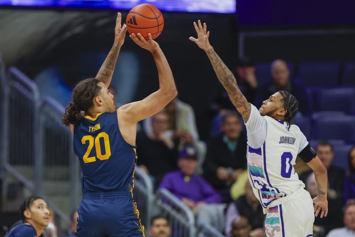 Feb 17, 2024; Seattle, Washington, USA; California Golden Bears guard Jaylon Tyson (20) makes a three-pointer against Washington Huskies guard Koren Johnson (0) during the first half at Alaska Airlines Arena at Hec Edmundson Pavilion.