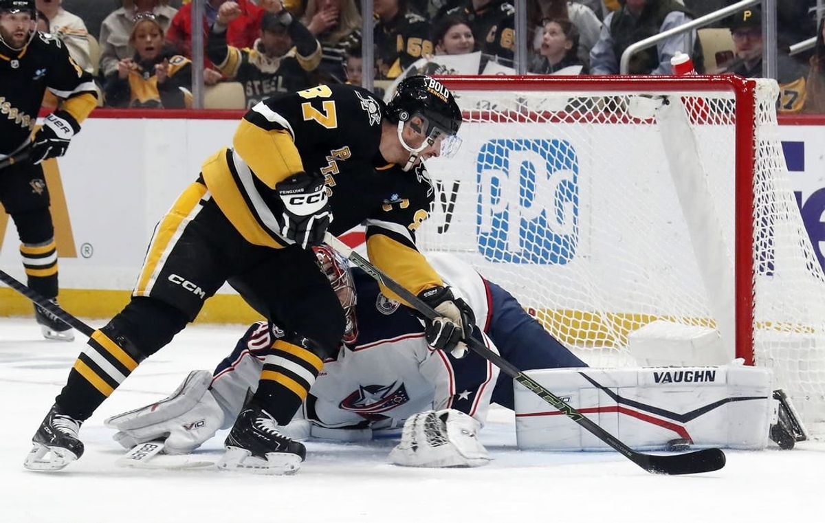 Mar 28, 2024; Pittsburgh, Pennsylvania, USA; Columbus Blue Jackets goaltender Daniil Tarasov (40) makes a pad save against Pittsburgh Penguins center Sidney Crosby (87) during the first period at PPG Paints Arena.