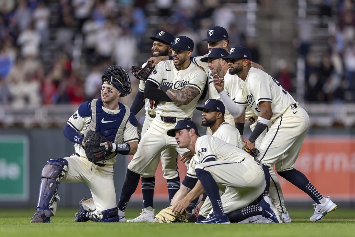 May 3, 2024; Minneapolis, Minnesota, USA; Members of the Minnesota Twins pose after defeating the Boston Red Sox and extending their winning streak to 11 games at Target Field.