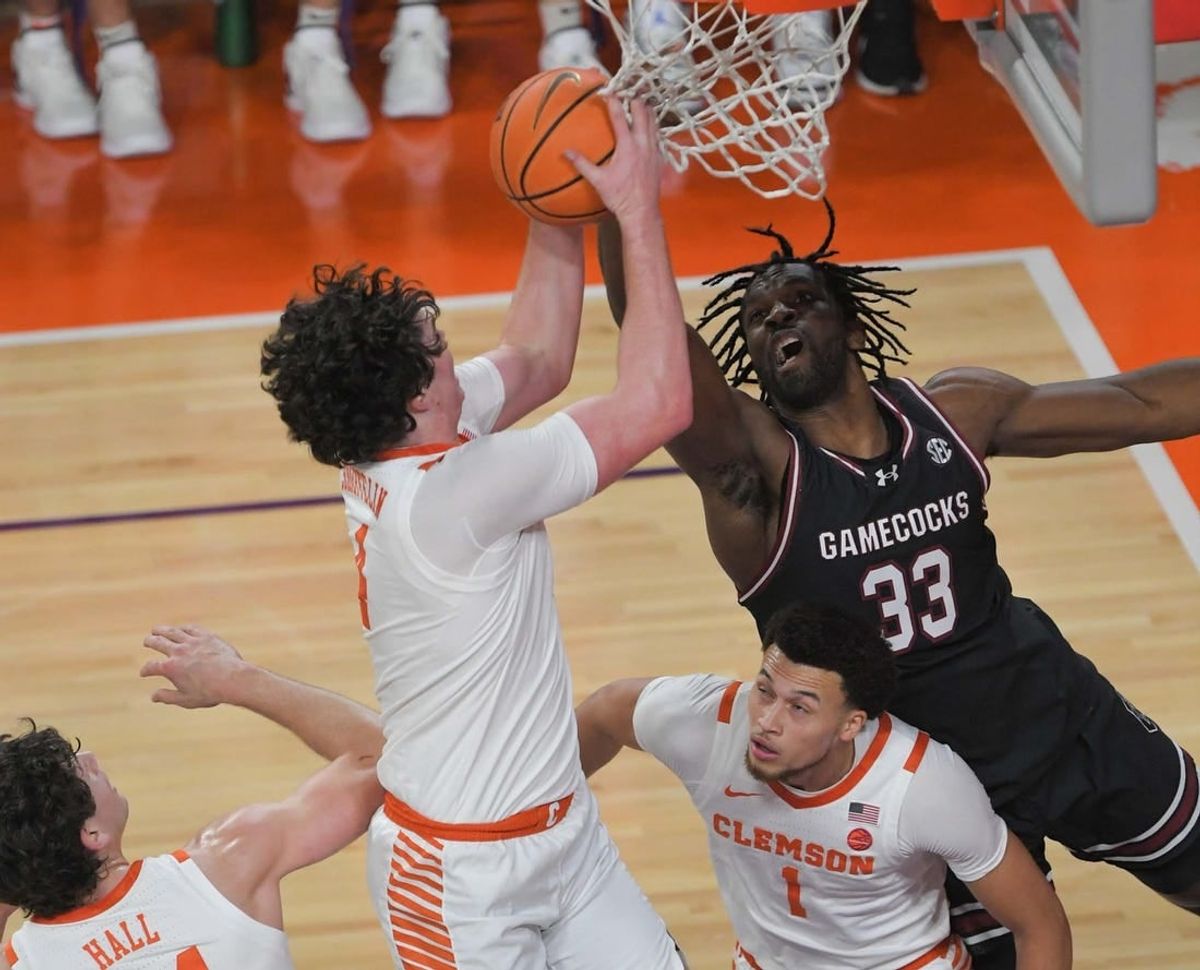 Dec 6, 2023; Clemson, South Carolina, USA; Clemson junior forward Ian Schieffelin (4) rebounds ear University of South Carolina forward Josh Gray (33) during the first half   at Littlejohn Coliseum.