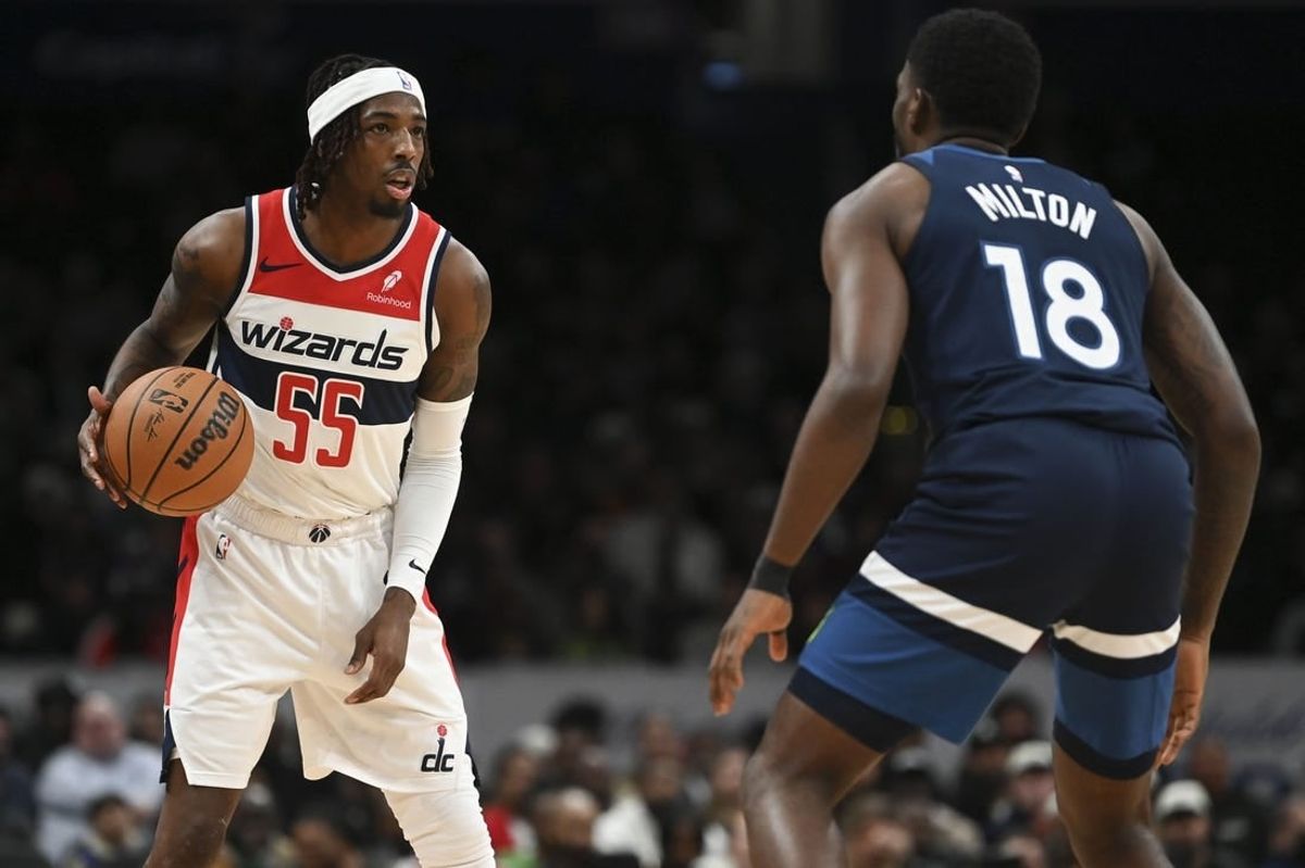 Jan 24, 2024; Washington, District of Columbia, USA; Washington Wizards guard Delon Wright (55) looks to pass as Minnesota Timberwolves guard Shake Milton (18) defends  during the second half at Capital One Arena.