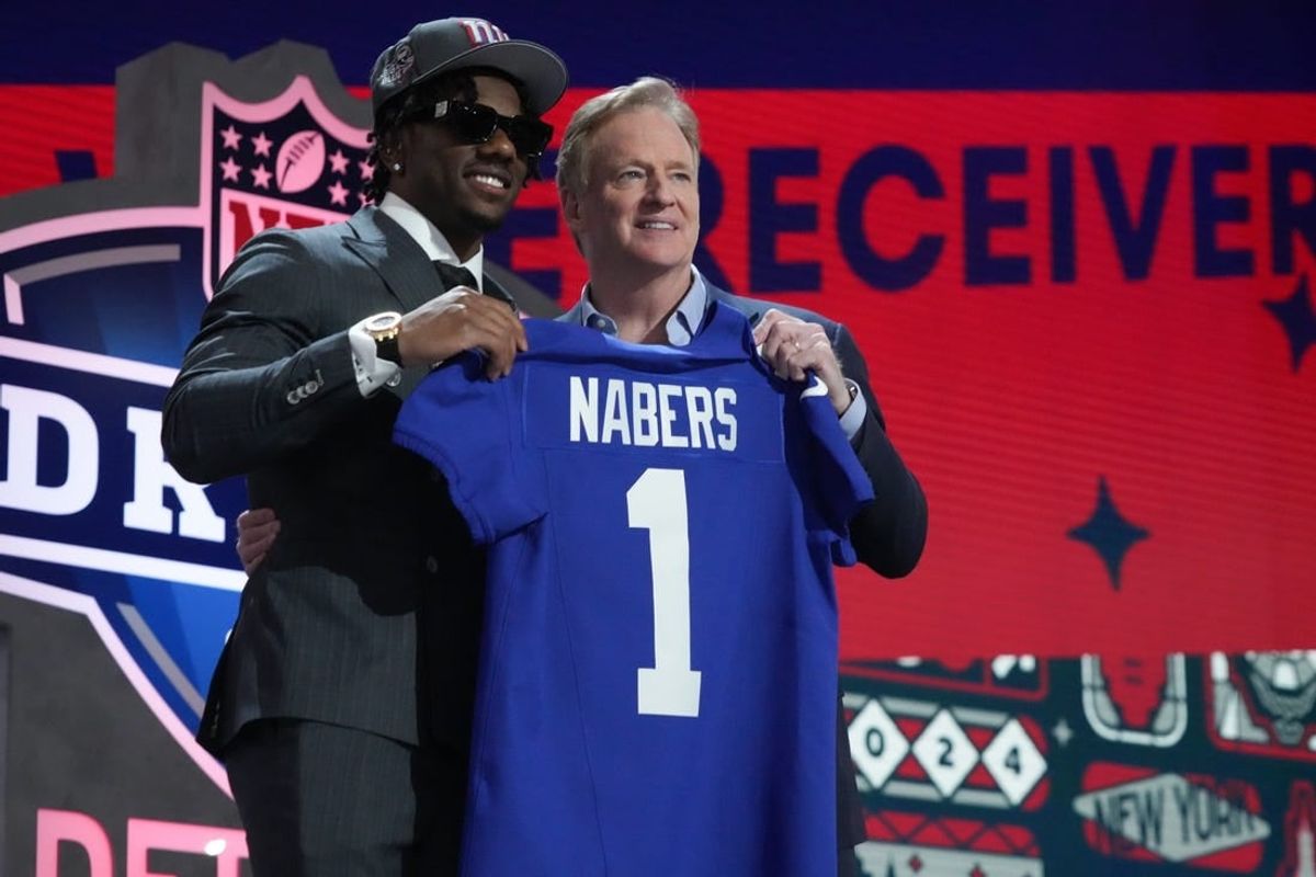 Apr 25, 2024; Detroit, MI, USA; LSU Tigers wide receiver Malik Nabers poses with NFL commissioner Roger Goodell after being selected by the New York Giants as the No. 6 pick in the first round of the 2024 NFL Draft at Campus Martius Park and Hart Plaza.