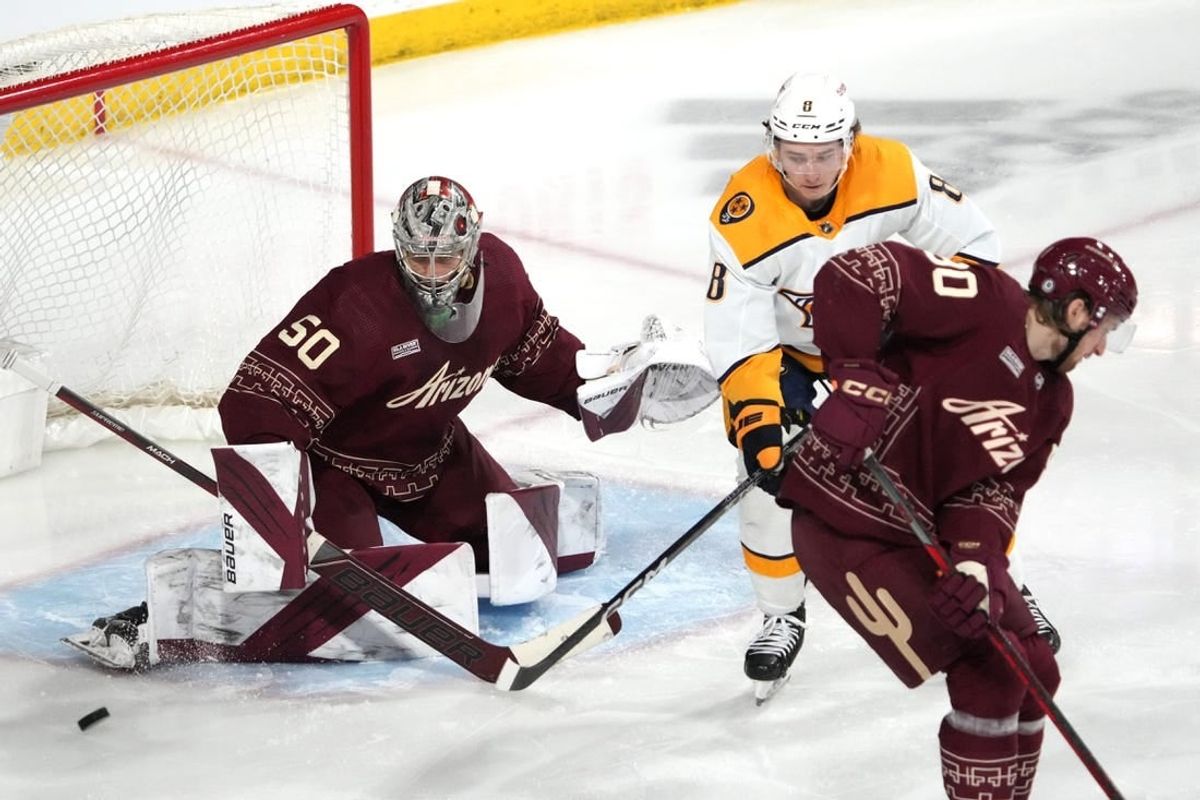 Mar 9, 2023; Tempe, Arizona, USA; Arizona Coyotes Ivan Prosvetov (50) makes a save in front of Nashville Predators center Cody Glass (8) during the third period at Mullett Arena.