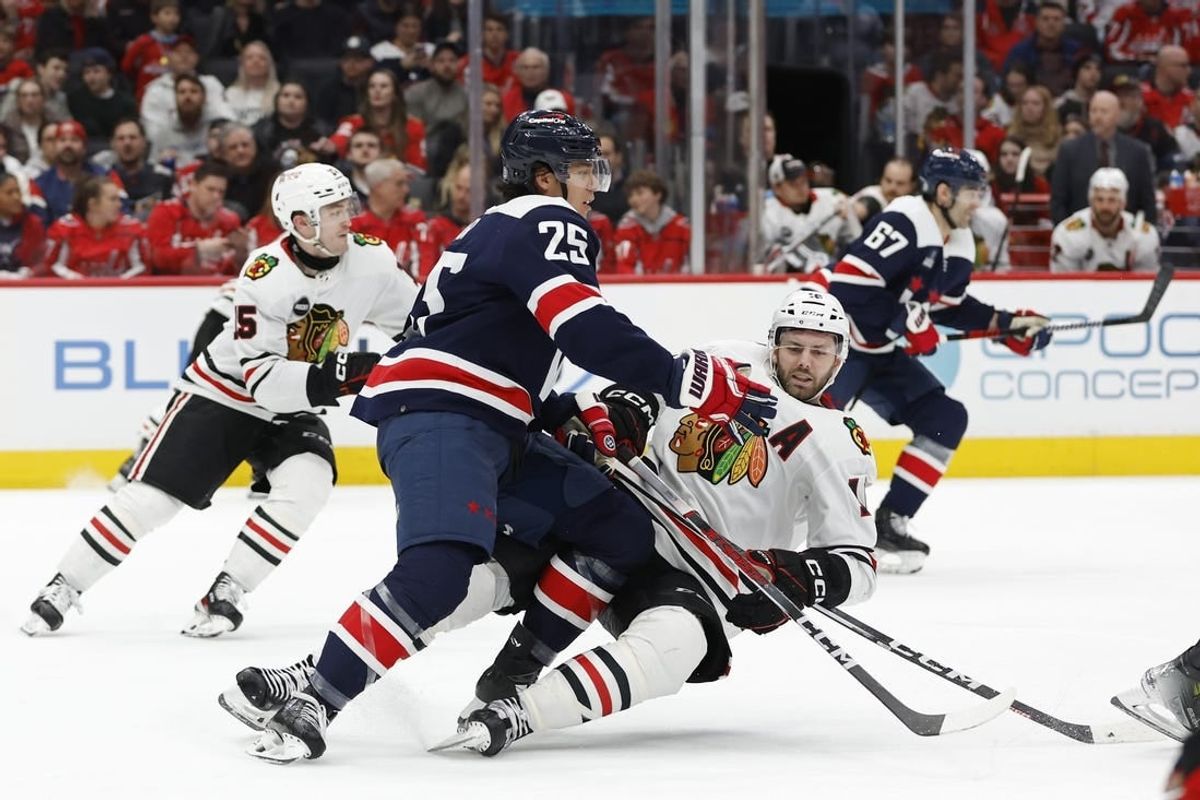 Mar 9, 2024; Washington, District of Columbia, USA; Washington Capitals defenseman Ethan Bear (25) checks Chicago Blackhawks center Jason Dickinson (16) in the second period at Capital One Arena.
