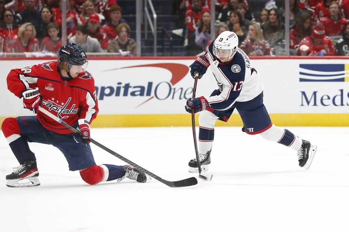 Nov 18, 2023; Washington, District of Columbia, USA; Columbus Blue Jackets left wing Johnny Gaudreau (13) shoots the puck as Washington Capitals defenseman Rasmus Sandin (38) defends during the second period at Capital One Arena.