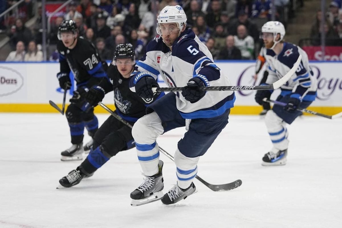 Jan 24, 2024; Toronto, Ontario, CAN; Winnipeg Jets defenseman Brenden Dillon (5) chases after a loose puck against the Toronto Maple Leafs during the third period at Scotiabank Arena.