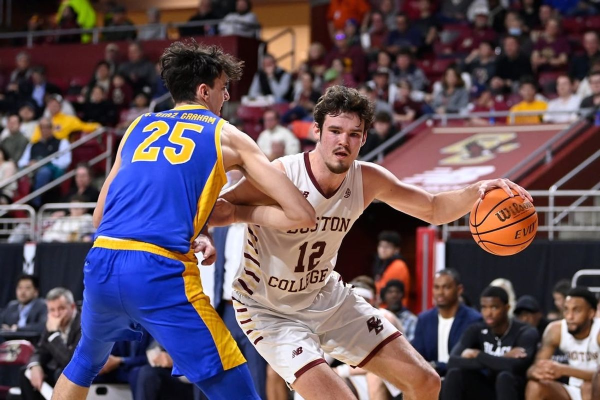 Mar 2, 2024; Chestnut Hill, Massachusetts, USA; Boston College Eagles forward Quinten Post (12) drives to the basket against Pittsburgh Panthers forward Guillermo Diaz Graham (25) during the second half at Conte Forum.