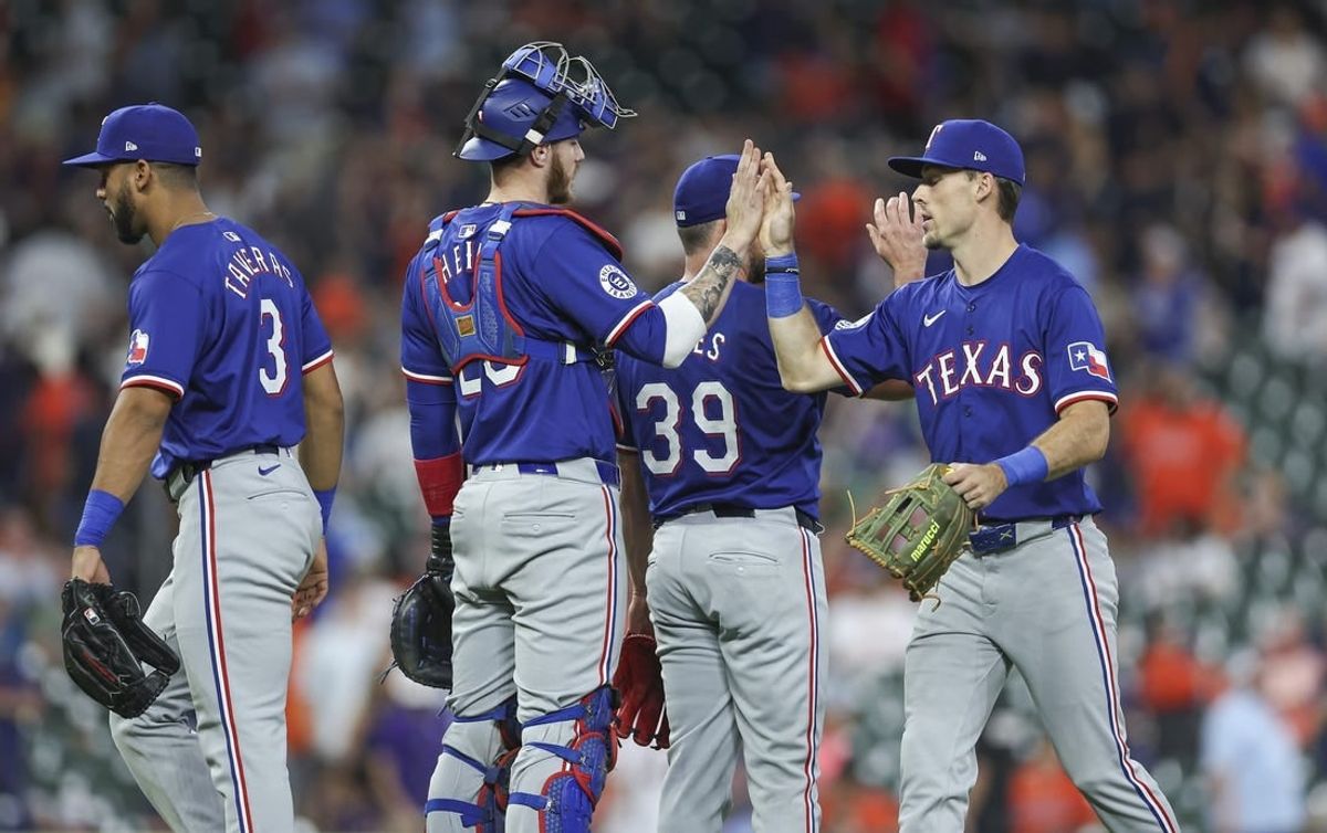 Apr 12, 2024; Houston, Texas, USA; Texas Rangers catcher Jonah Heim (28) celebrates with left fielder Evan Carter (32) after the game against the Houston Astros at Minute Maid Park.