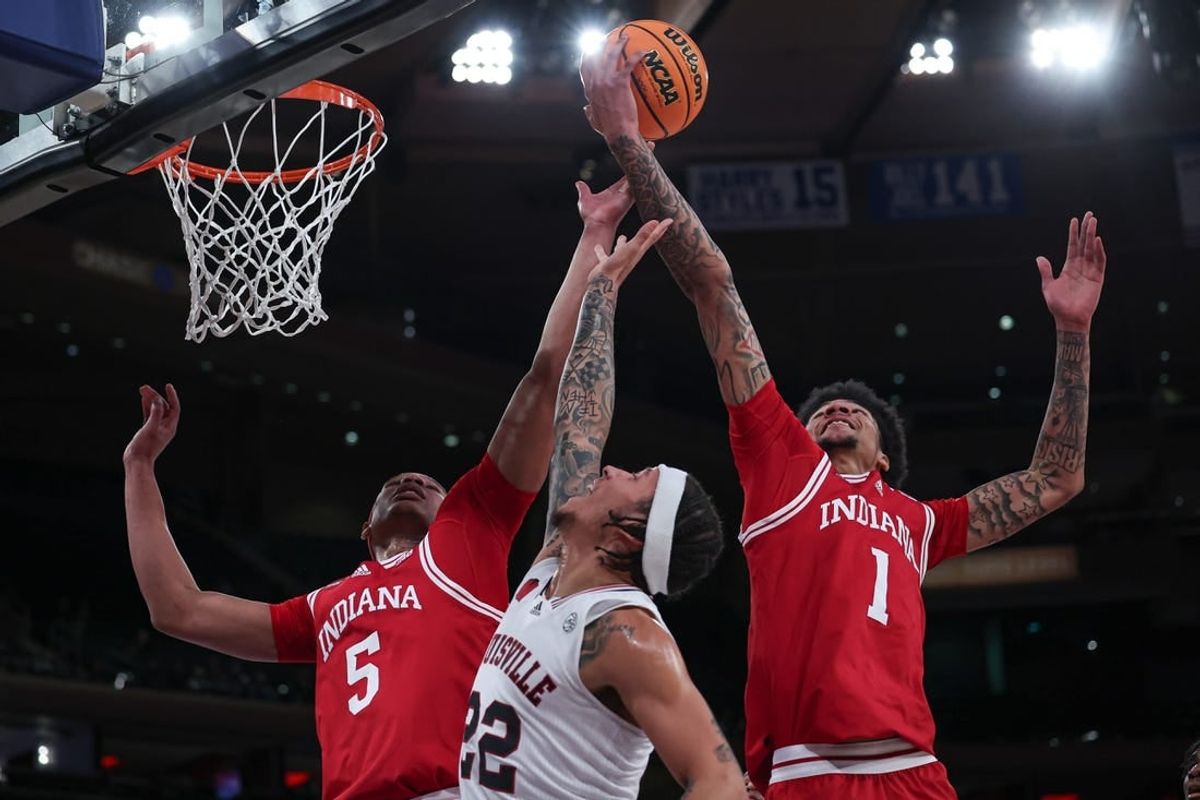 Nov 20, 2023; New York, NY, USA; Louisville Cardinals guard Tre White (22) rebounds against Indiana Hoosiers forward Malik Reneau (5) and center Kel'el Ware (1) during the first half at Madison Square Garden.