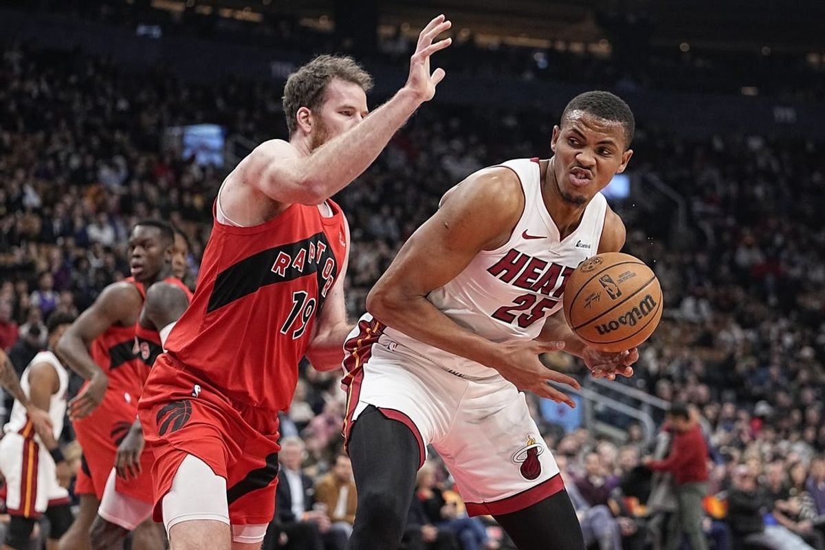 Dec 6, 2023; Toronto, Ontario, CAN; Miami Heat center Orlando Robinson (25) tries to around Toronto Raptors center Jakob Poeltl (19) during the first half at Scotiabank Arena.