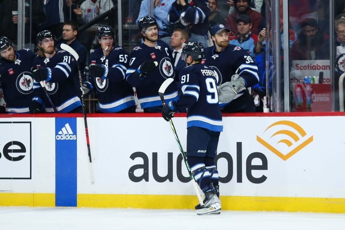 Nov 11, 2023; Winnipeg, Manitoba, CAN;  Winnipeg Jets forward Cole Perfetti (91) is congratulated by his teammates on his goal against the Dallas Stars during the second period at Canada Life Centre.