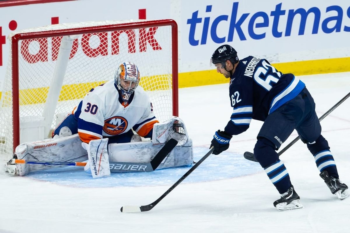 Jan 16, 2024; Winnipeg, Manitoba, CAN; New York Islanders goalie Ilya Sorokin (30) prepares for a shot by Winnipeg Jets forward Nino Niederreiter (62) during the third period at Canada Life Centre.