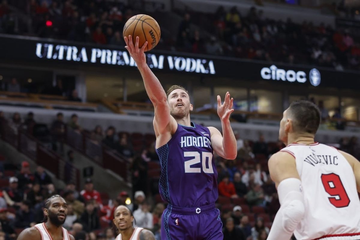 Dec 6, 2023; Chicago, Illinois, USA; Charlotte Hornets forward Gordon Hayward (20) goes to the basket against Chicago Bulls center Nikola Vucevic (9) during the first half at United Center.