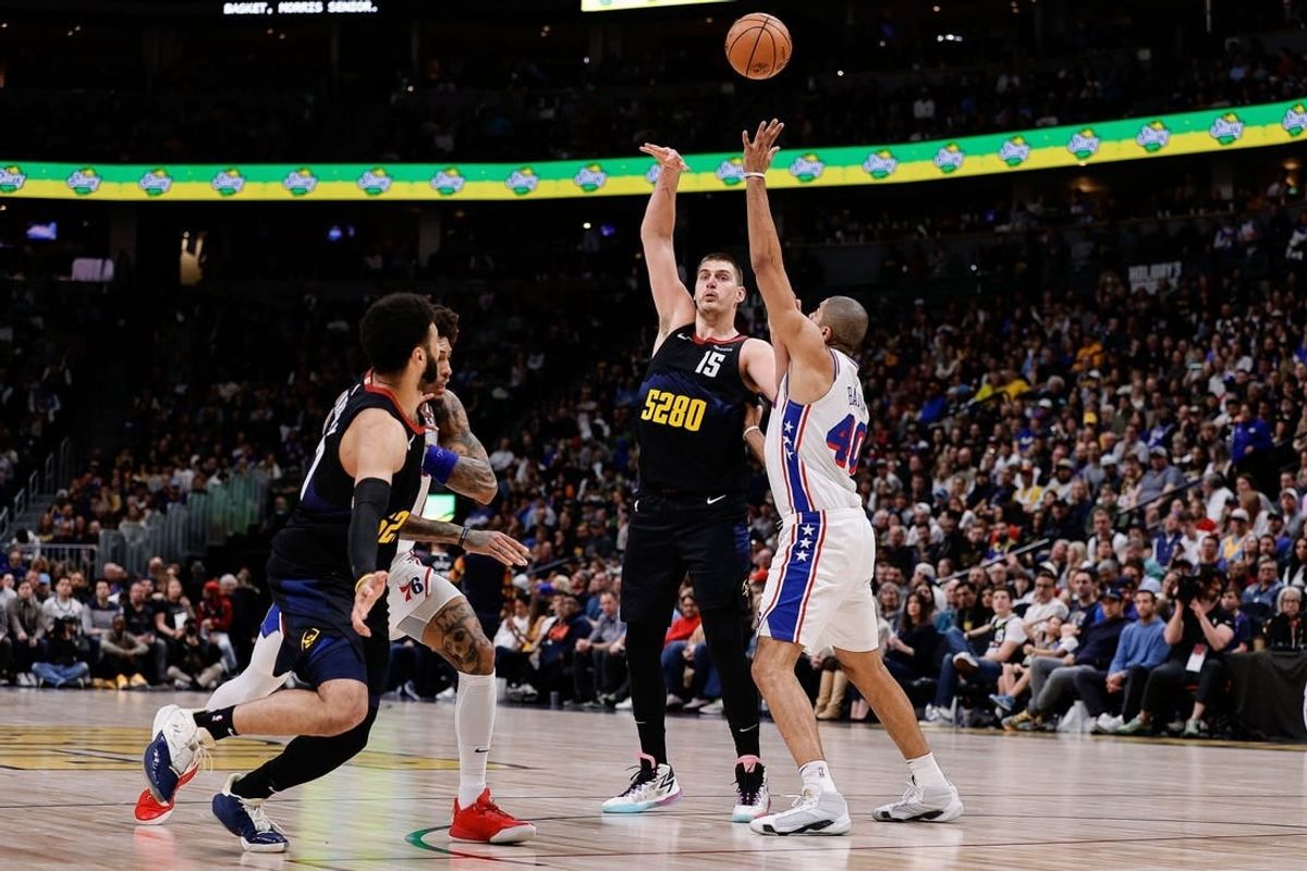 Jan 27, 2024; Denver, Colorado, USA; Denver Nuggets center Nikola Jokic (15) looks to pass the ball to guard Jamal Murray (27) as Philadelphia 76ers forward Nicolas Batum (40) and guard Kelly Oubre Jr. (9) defend in the second quarter at Ball Arena.