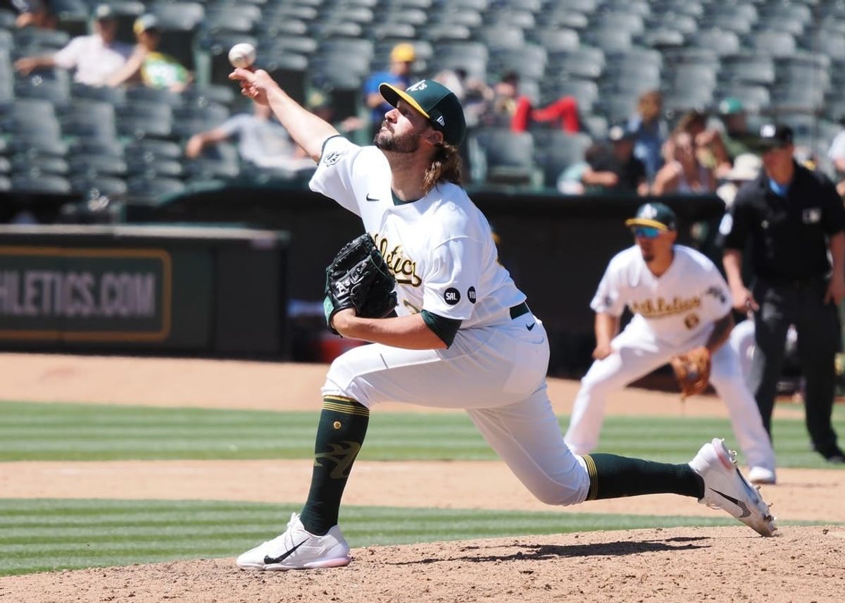 Jul 23, 2023; Oakland, California, USA; Oakland Athletics   relief pitcher Chad Smith (3) pitches the ball against the Houston Astros during the eighth inning at Oakland-Alameda County Coliseum.