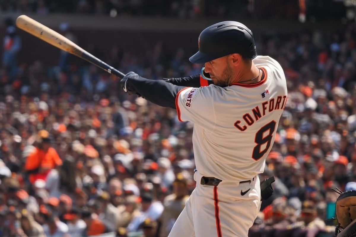 Apr 5, 2024; San Francisco, California, USA; San Francisco Giants left fielder Michael Conforto (8) hits an RBI double against the San Diego Padres during the first inning at Oracle Park.