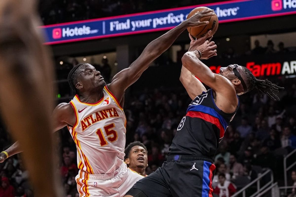 Apr 3, 2024; Atlanta, Georgia, USA; Detroit Pistons forward Tosan Evbuomwan (18) has his shot blocked by Atlanta Hawks center Clint Capela (15) during the second half at State Farm Arena.