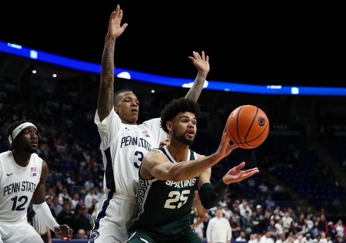Feb 14, 2024; University Park, Pennsylvania, USA; Michigan State Spartans forward Malik Hall (25) passes the ball as Penn State Nittany Lions guard Nick Kern Jr (3) defends during the second half at Bryce Jordan Center. Michigan State defeated Penn State 80-72.