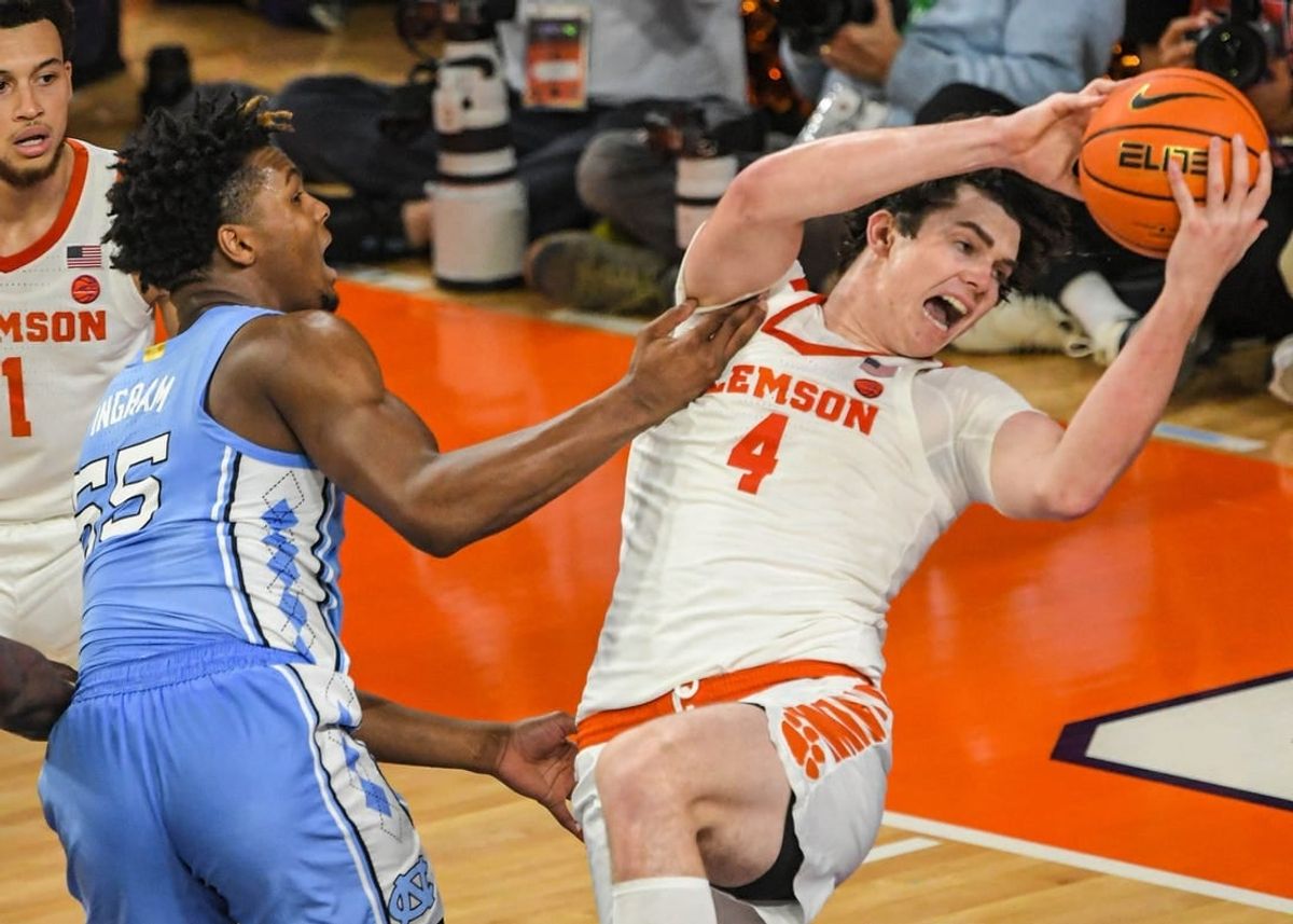 Jan 6, 2024; Clemson, South Carolina, USA; Clemson junior forward Ian Schieffelin (4) rebounds near University of North Carolina forward Harrison Ingram (55) during the first half at Littlejohn Coliseum.
