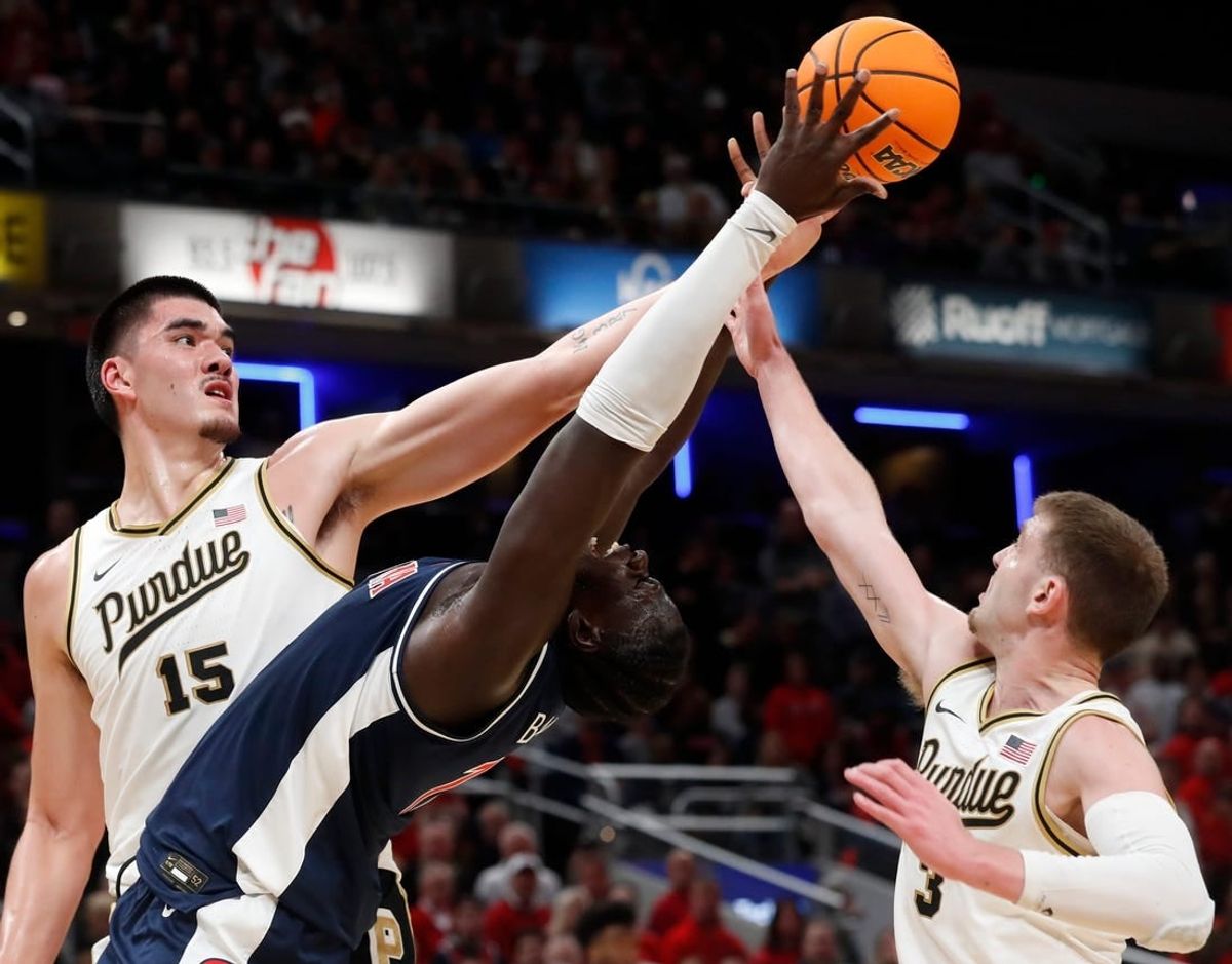 Purdue Boilermakers center Zach Edey (15), Arizona Wildcats center Oumar Ballo (11) and Purdue Boilermakers guard Braden Smith (3) fight for a rebound during the NCAA men   s basketball game, Saturday, Dec. 16, 2023, at Gainbridge Fieldhouse in Indianapolis. Purdue Boilermakers won 92-84.