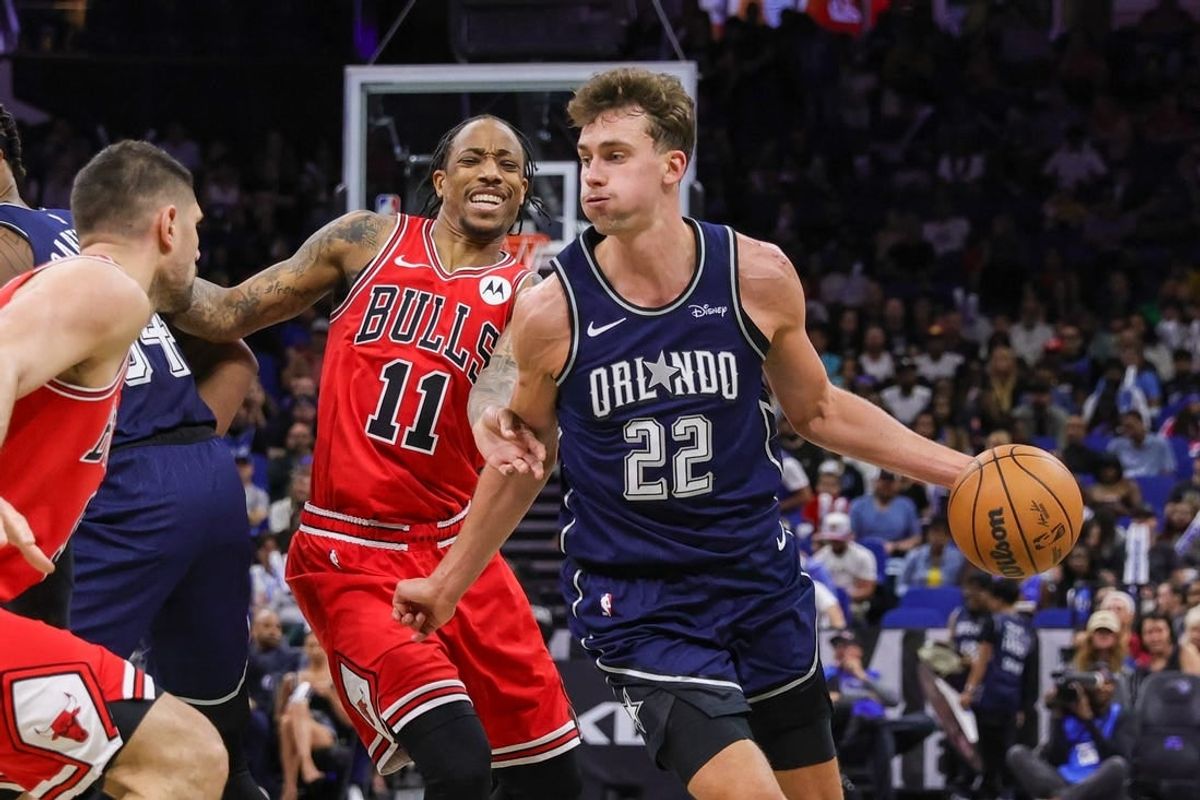 Apr 7, 2024; Orlando, Florida, USA; Orlando Magic forward Franz Wagner (22) moves the ball around Chicago Bulls forward DeMar DeRozan (11) during the second quarter at KIA Center.