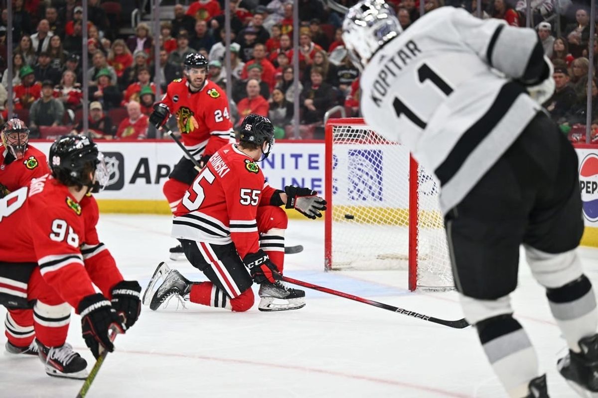 Mar 15, 2024; Chicago, Illinois, USA; Los Angeles Kings forward Anze Kopitar (11) scores into an nearly empty net in the first period against the Chicago Blackhawks at United Center.
