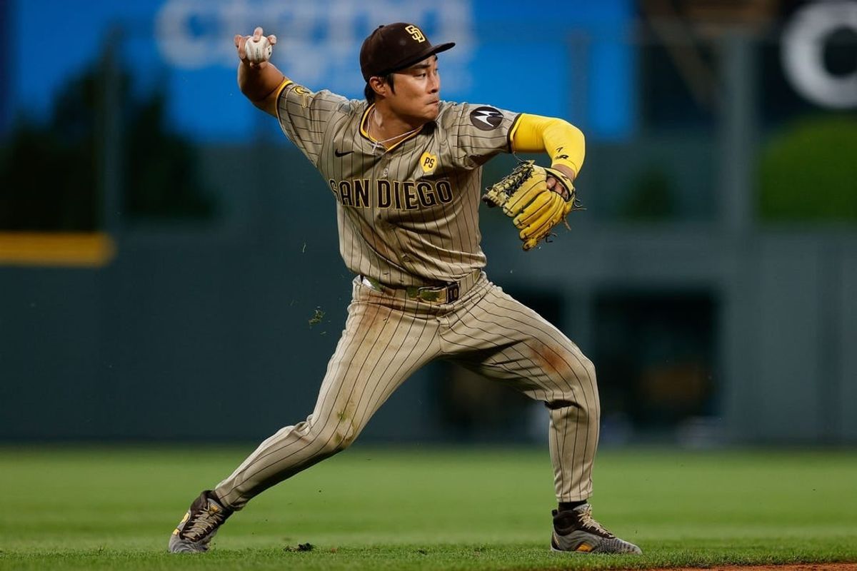 Apr 24, 2024; Denver, Colorado, USA; San Diego Padres shortstop Ha-Seong Kim (7) fields and throws to first in the fourth inning against the Colorado Rockies at Coors Field.