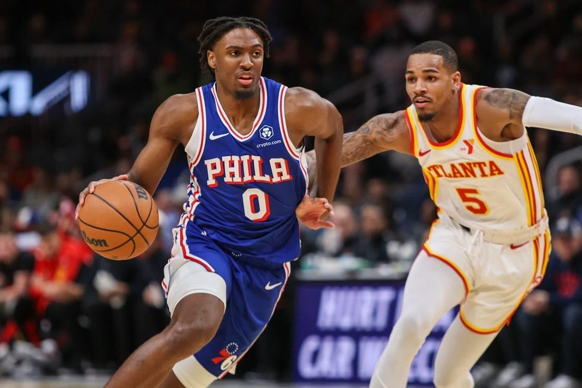 Jan 10, 2024; Atlanta, Georgia, USA; Philadelphia 76ers guard Tyrese Maxey (0) drives on Atlanta Hawks guard Dejounte Murray (5) in the first quarter at State Farm Arena.