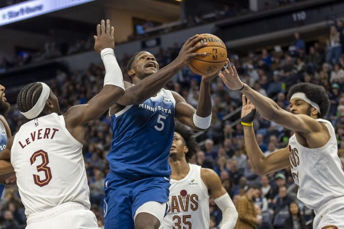 Mar 22, 2024; Minneapolis, Minnesota, USA; Minnesota Timberwolves guard Anthony Edwards (5) drives to the basket past Cleveland Cavaliers center Jarrett Allen (31) and Cleveland Cavaliers guard Caris LeVert (3) in the second half at Target Center.