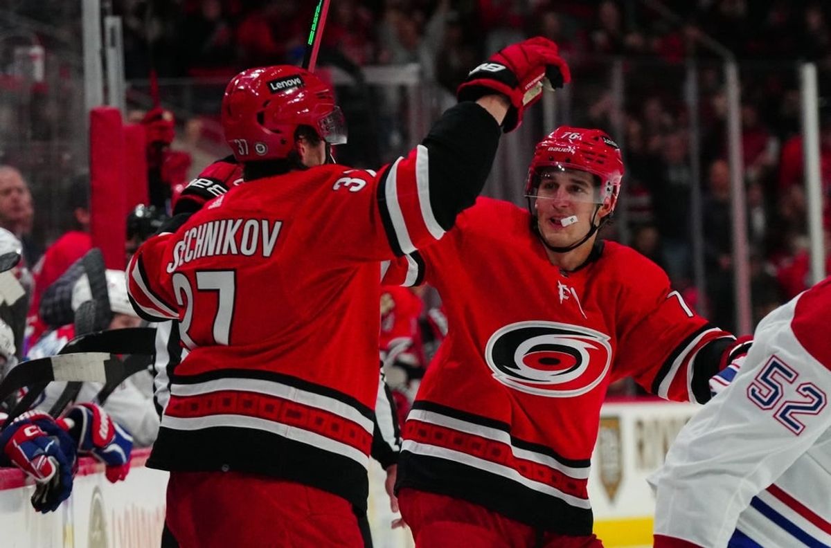 Dec 28, 2023; Raleigh, North Carolina, USA; Carolina Hurricanes right wing Andrei Svechnikov (37) celebrates his goal with defenseman Brady Skjei (76) against the Montreal Canadiens during the third period at PNC Arena.