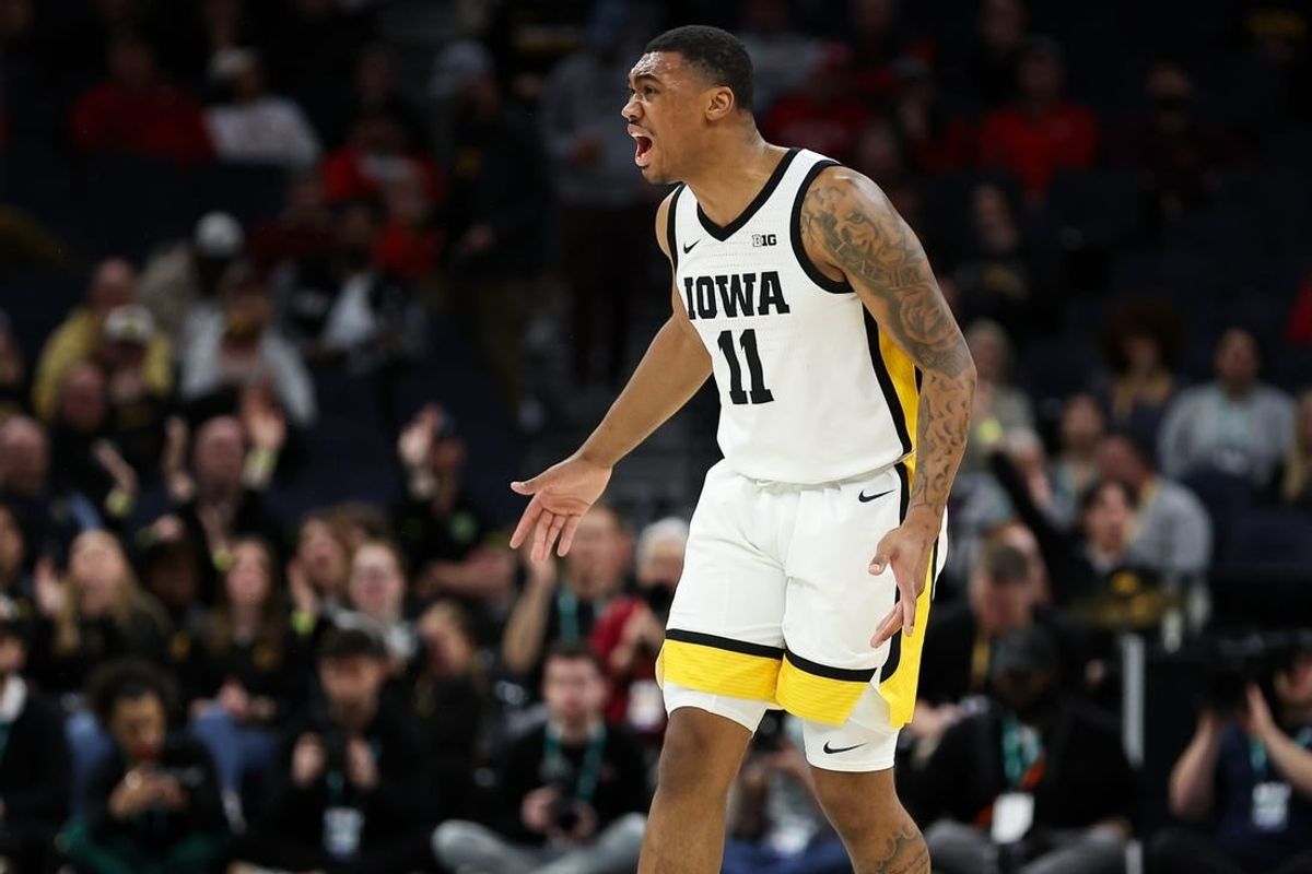 Mar 14, 2024; Minneapolis, MN, USA; Iowa Hawkeyes guard Tony Perkins (11) celebrates during the first half against the Ohio State Buckeyes at Target Center.