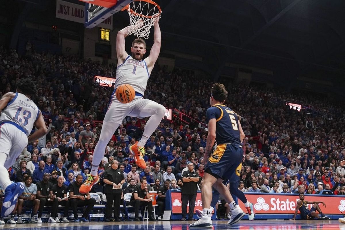 Dec 5, 2023; Lawrence, Kansas, USA; Kansas Jayhawks center Hunter Dickinson (1) dunks the ball as UMKC Kangaroos guard Jamar Brown (5) looks on during the first half at Allen Fieldhouse.