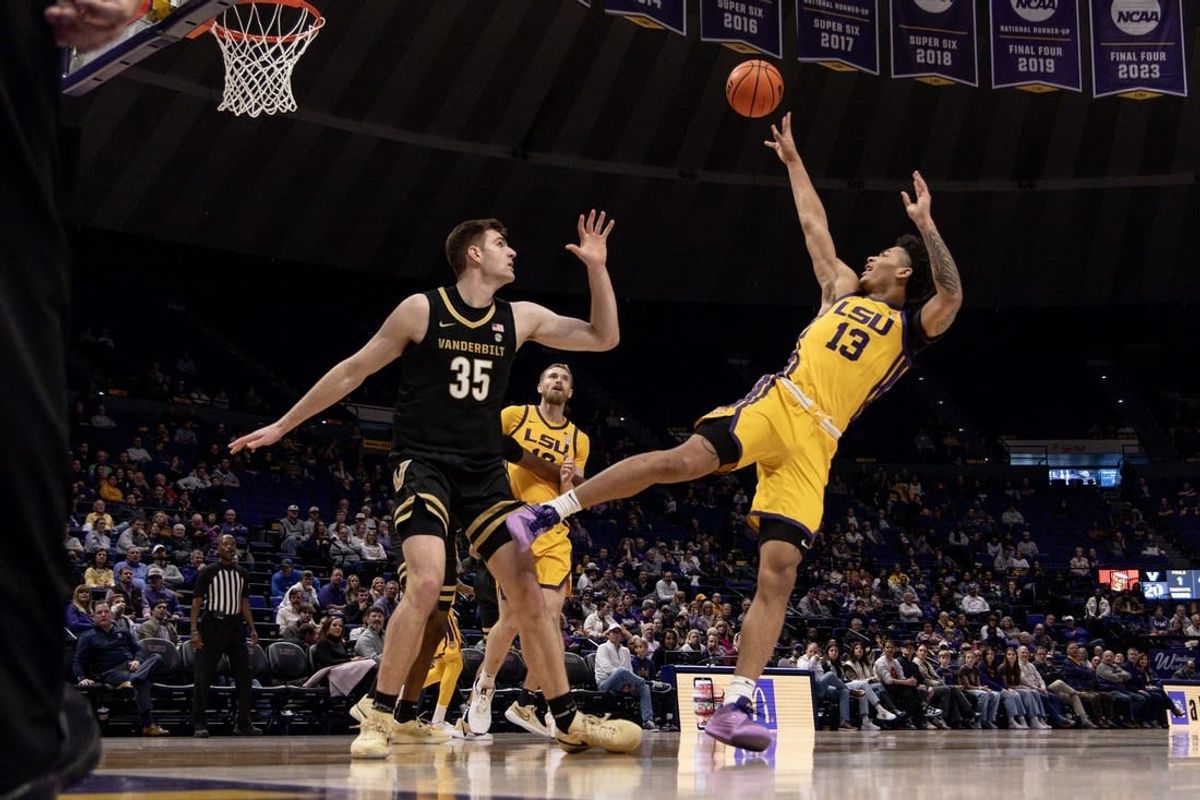 Jan 9, 2024; Baton Rouge, Louisiana, USA; LSU Tigers forward Jalen Reed (13) shoots a jump shot against Vanderbilt Commodores forward Carter Lang (35) during the first half at Pete Maravich Assembly Center.