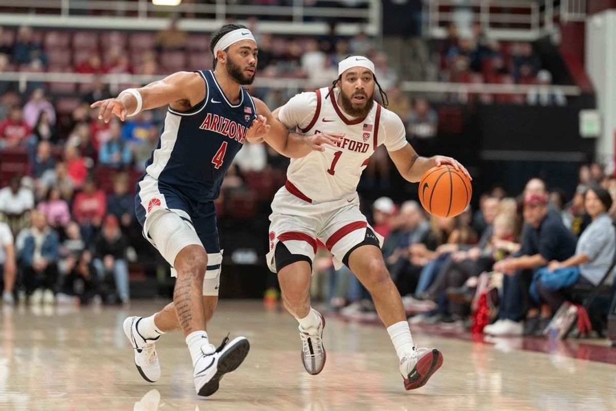 Dec 31, 2023; Stanford, California, USA; Stanford Cardinal guard Jared Bynum (1) drives the ball against Arizona Wildcats guard Kylan Boswell (4) during the first half at Maples Pavilion.