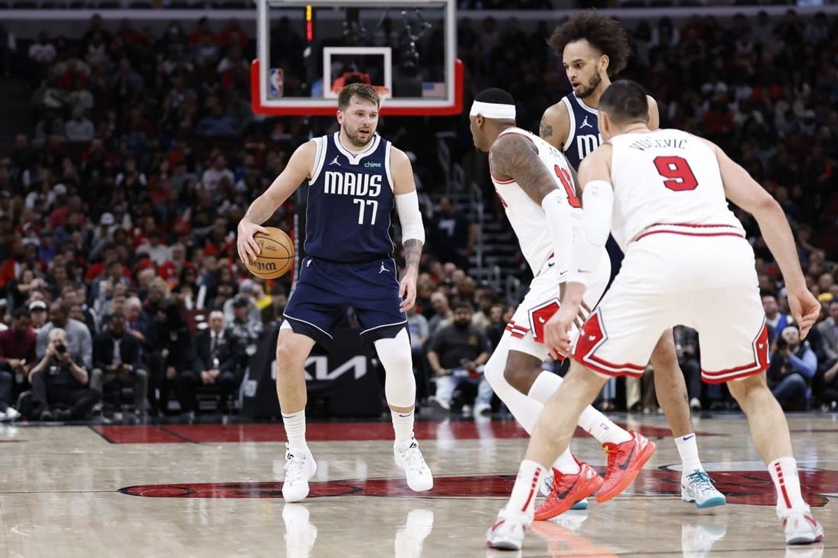 Mar 11, 2024; Chicago, Illinois, USA; Dallas Mavericks guard Luka Doncic (77) brings the ball up court against the Chicago Bulls during the second half at United Center.