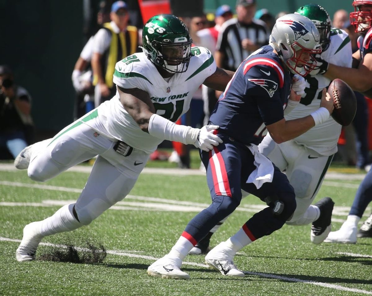 John Franklin-Myers of the Jets knocks the ball from Patriots quarterback Mac Jones as the New England Patriots defeated the NY Jets 25-6 at MetLife Stadium in East Rutherford, NJ on September 19, 2021.

The New England Patriots Came To Play The Ny Jets At Metlife Stadium In East Rutherford Nj On September 19 2021