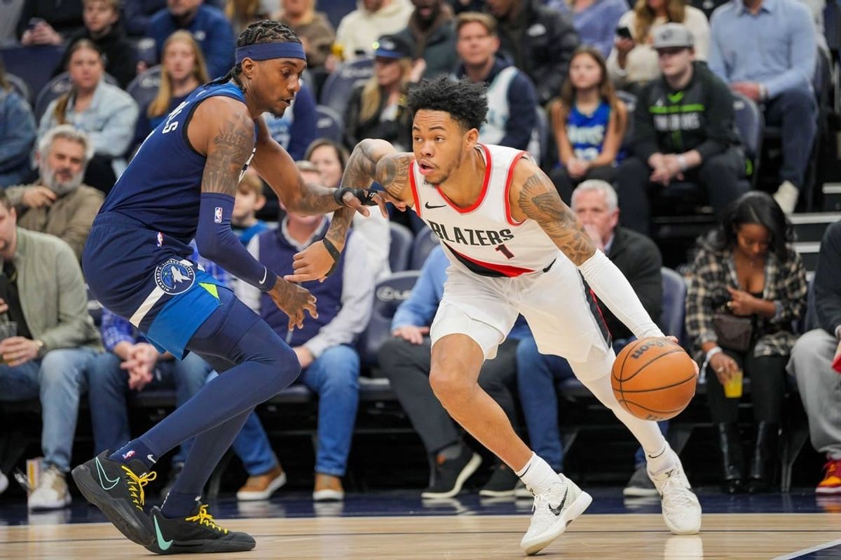 Mar 4, 2024; Minneapolis, Minnesota, USA; Portland Trail Blazers guard Anfernee Simons (1) dribbles against the Minnesota Timberwolves forward Jaden McDaniels (3) in the first quarter at Target Center.