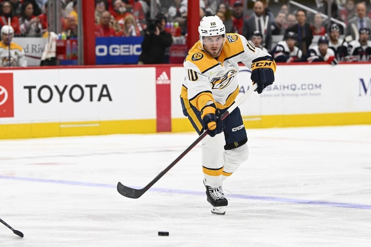 Dec 30, 2023; Washington, District of Columbia, USA; Nashville Predators center Colton Sissons (10) passes the puck against the Washington Capitals during the second period at Capital One Arena.