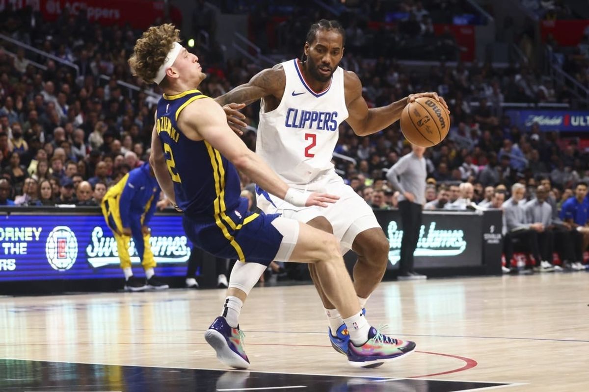 Dec 14, 2023; Los Angeles, California, USA; LA Clippers forward Kawhi Leonard (2) dribbles against Golden State Warriors guard Brandin Podziemski (2) and draws an offensive foul during the second half of the game at Crypto.com Arena.