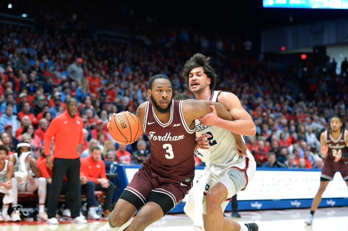 Feb 17, 2024; Dayton, Ohio, USA; Fordham Rams guard Jahmere Tripp (3) drives against Dayton Flyers forward Nate Santos (2) during a game at University of Dayton Arena.